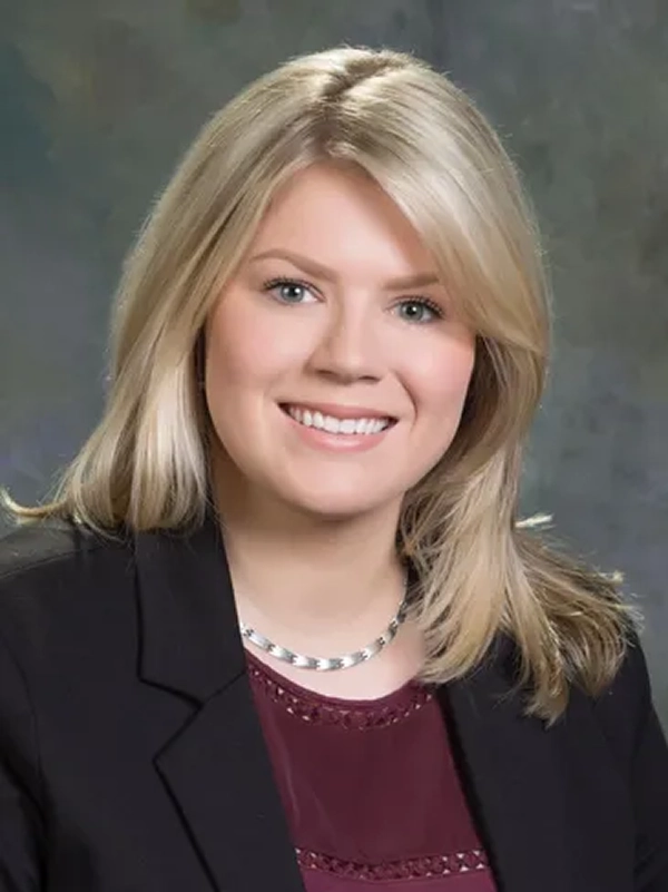 1 Smiling woman in a professional portrait.