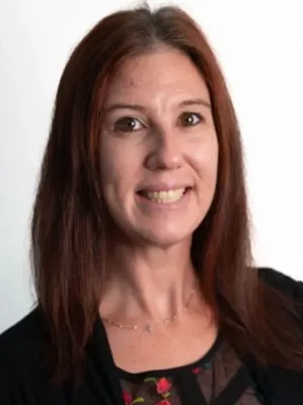 7 Smiling woman with long brown hair.